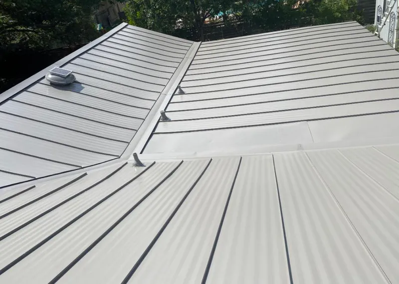 Solar attic fan installed on a metal roof for Roof Ventilation in Hingham